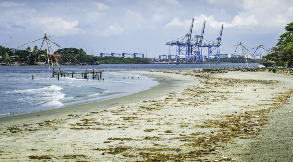 Fort Kochi tropical beach with heavy industry in background