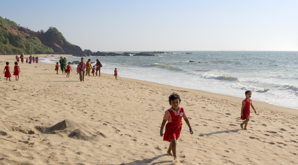 Children play on the beach in Goa, India