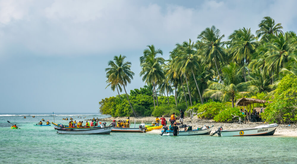 Kalpeni Island, Lakshadweep - Arabian Ocean, tourists engage in water sports in blue sea of tropical island
