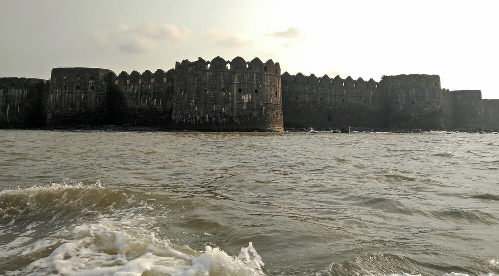 Boat view of the Murud Janjira Fort at sunset built in the ocean in India