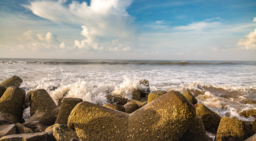 Sea waves splashing against the beach rocks at Digha beach, West Bengal, India